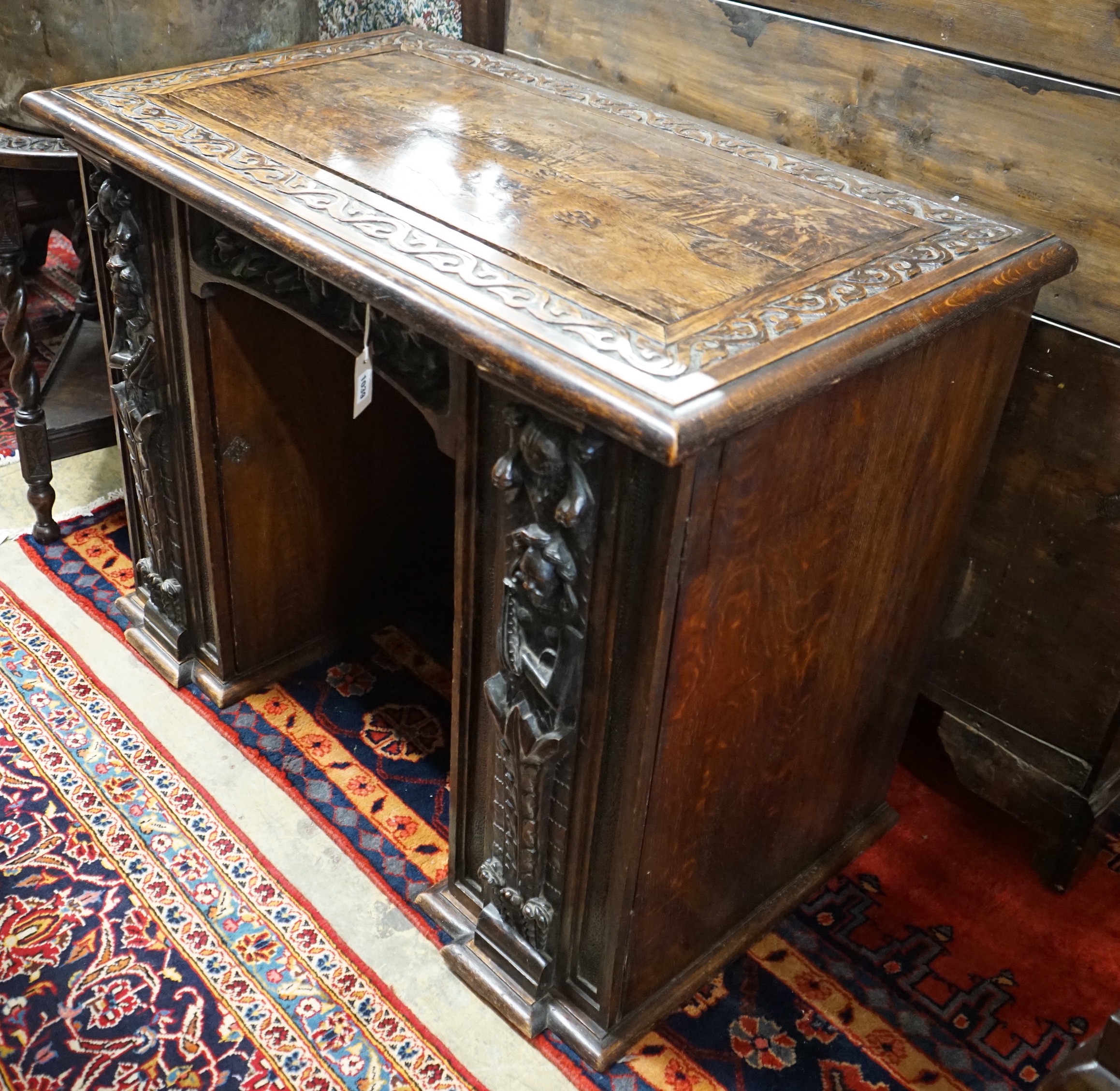 An 18th century carved oak kneehole desk, width 105cm, depth 59cm, height 81cm